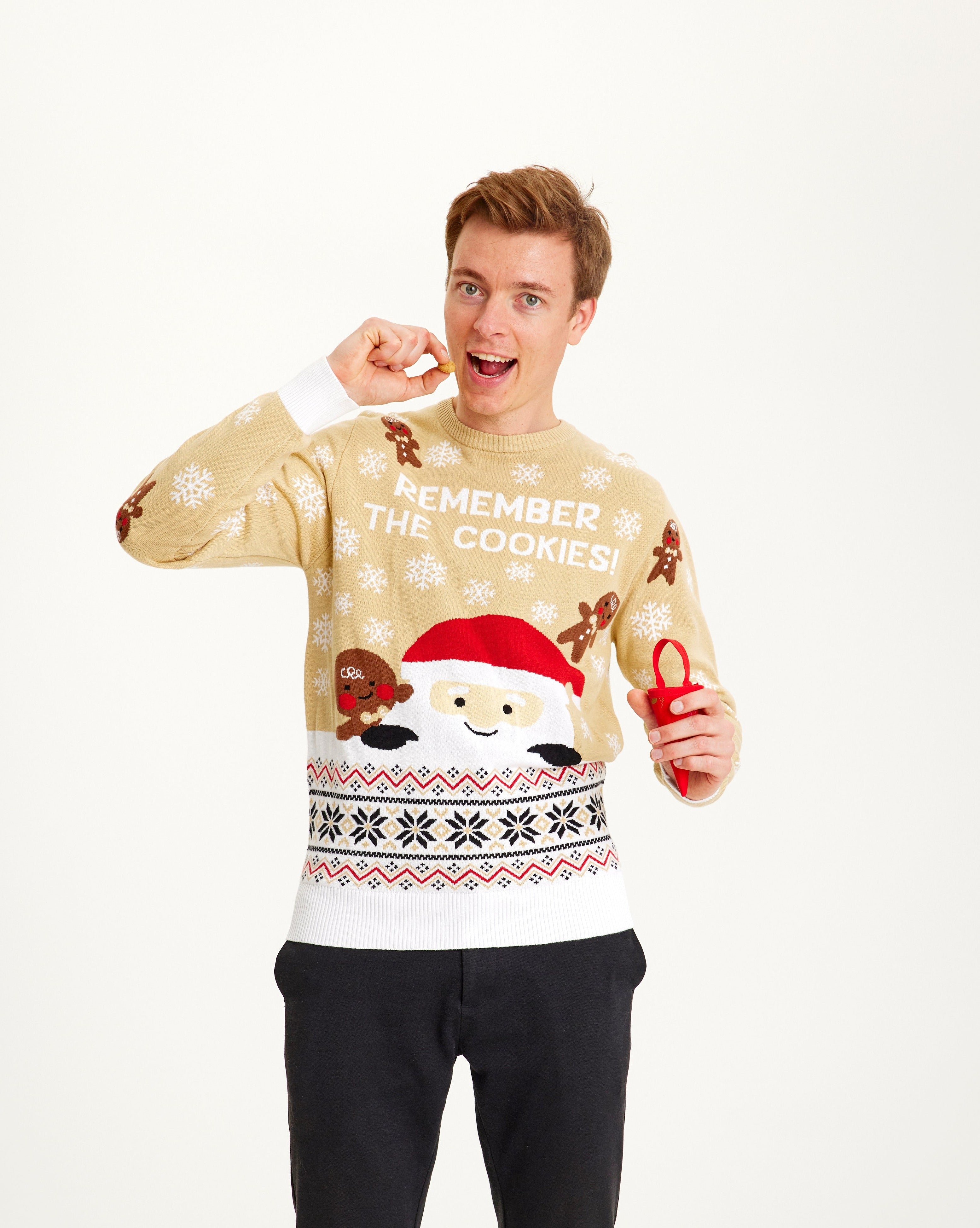 Un homme portant un pull de Noël beige.